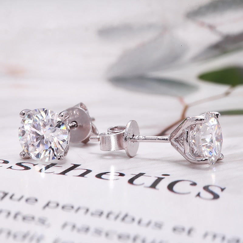 A pair of silver moissanite studs.