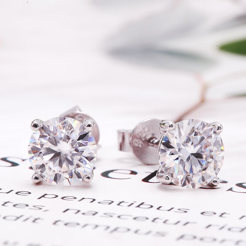 A pair of silver moissanite studs.