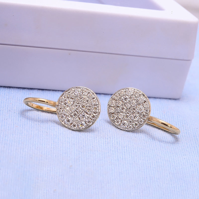 A pair of gold tone round gem encrusted drop earrings.