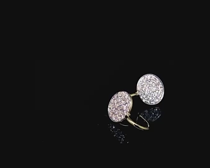 A pair of gold tone round gem encrusted drop earrings on a spinning viewing platform.