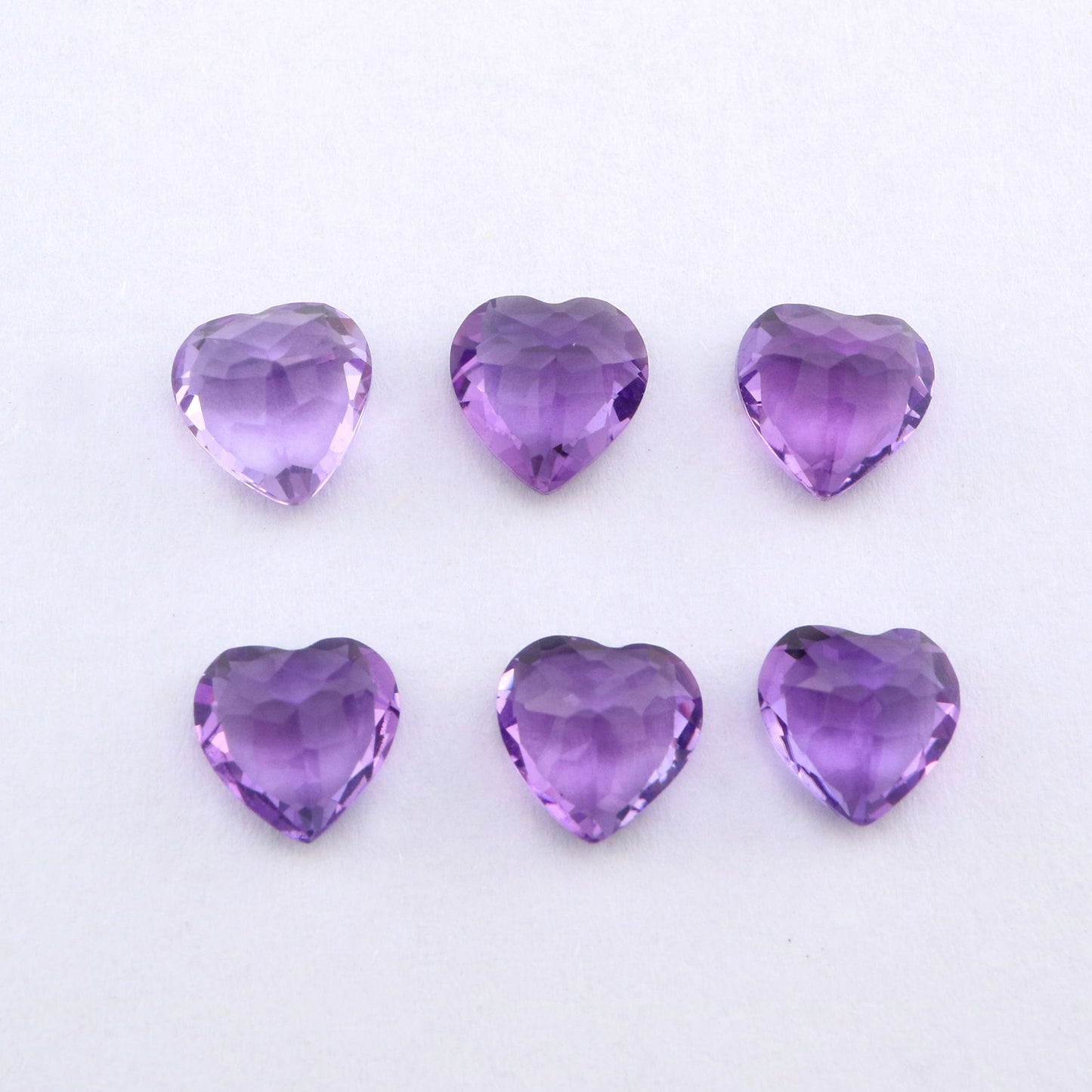 Six heart cut purple amethysts.
