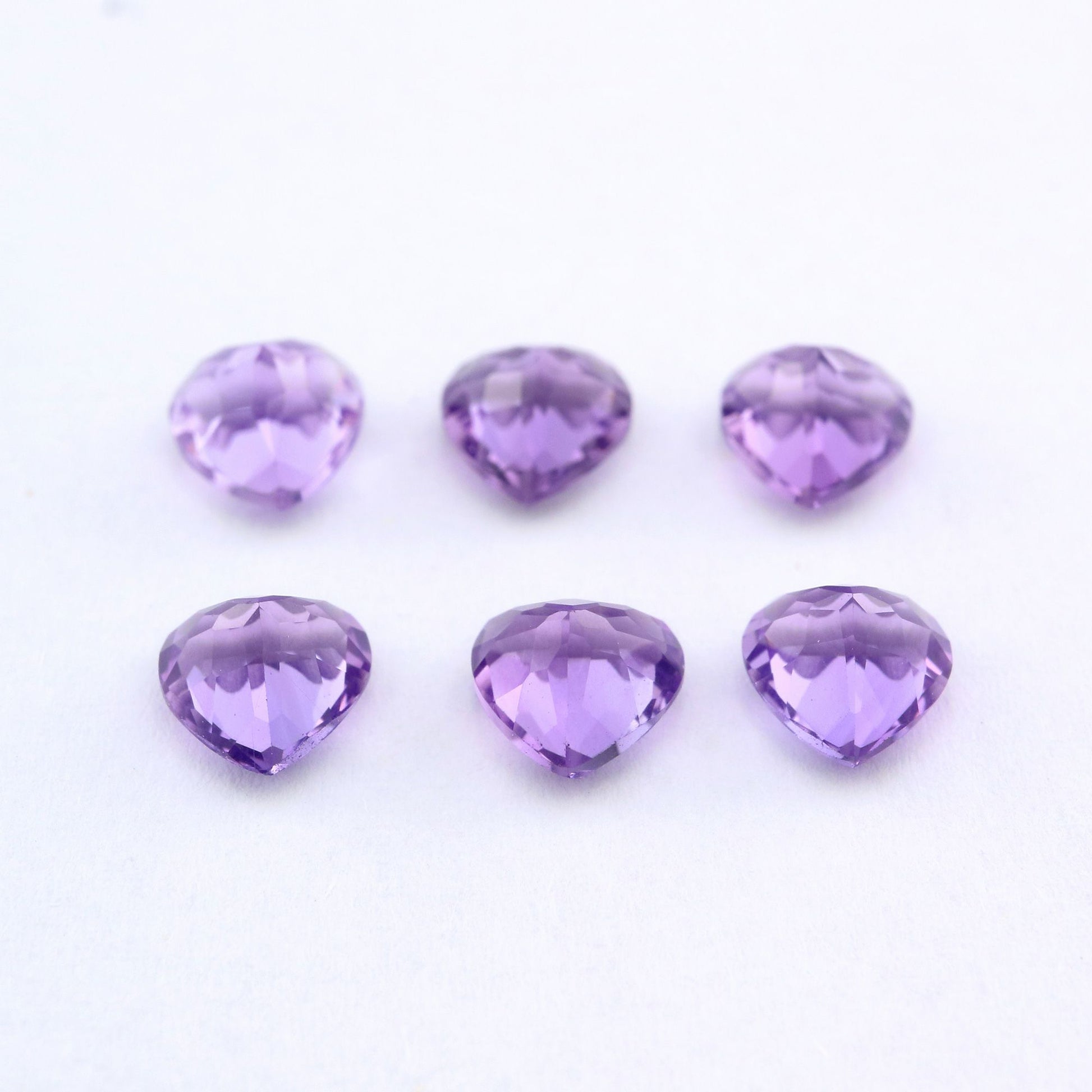 Six heart cut purple amethysts.