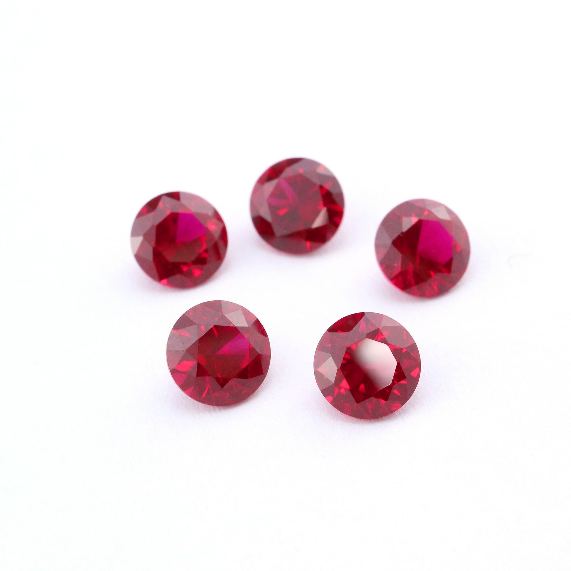 Five round cut red lab created ruby.