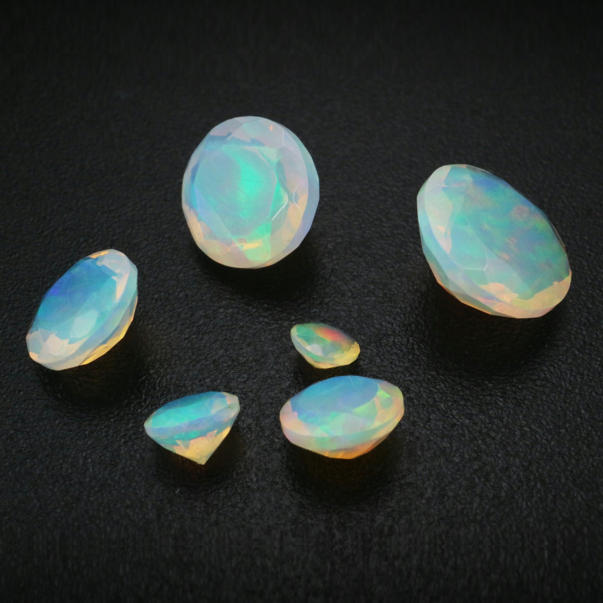 Various sizes of loose colorful opals.