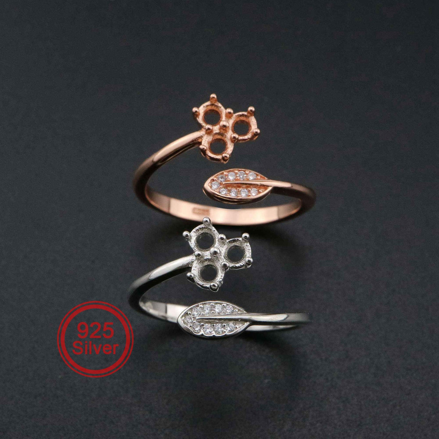 One silver and one rose gold bypass rings setting with a leaf on one side and a semi mount for three small round gems on the other.