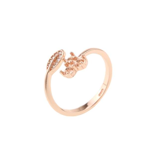 A rose gold bypass ring setting with a leaf on one side and a semi mount for three small round gems on the other.