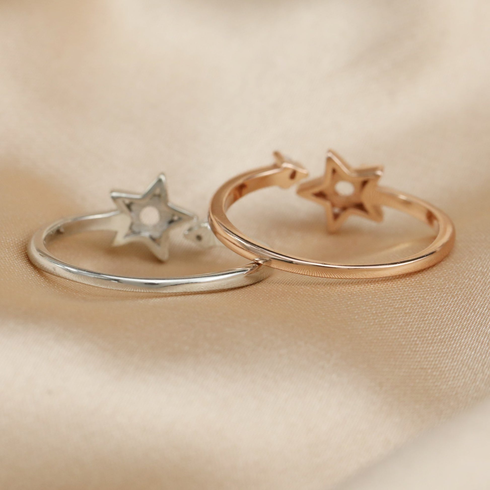 One silver and one rose gold one size fits all star and arrow semi mount for a round gem.