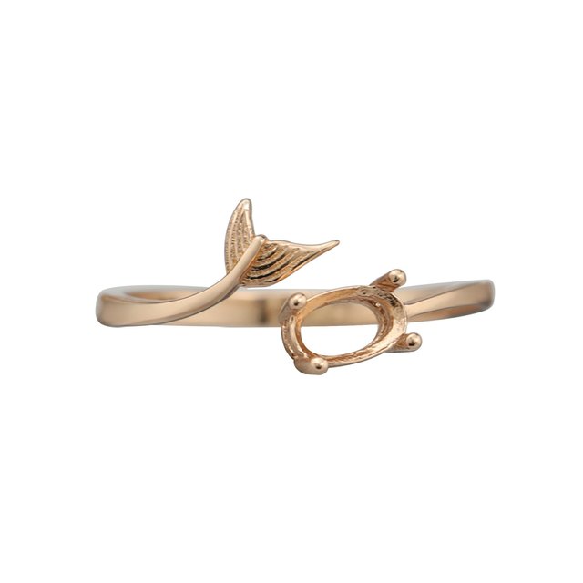 A rose gold oval wrap around ring with a mermaid tail on the opposite end.