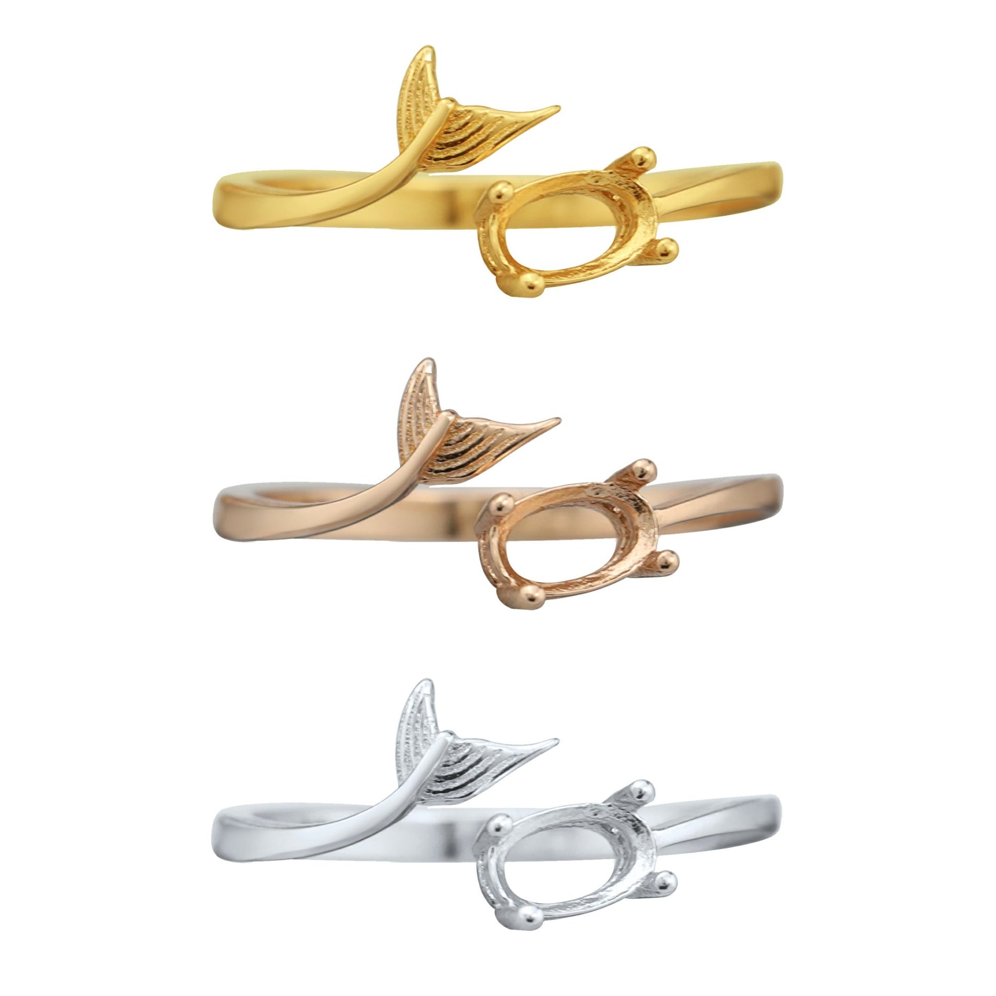 One silver, one gold and one rose gold oval wrap around rings with a mermaid tail on the opposite ends.