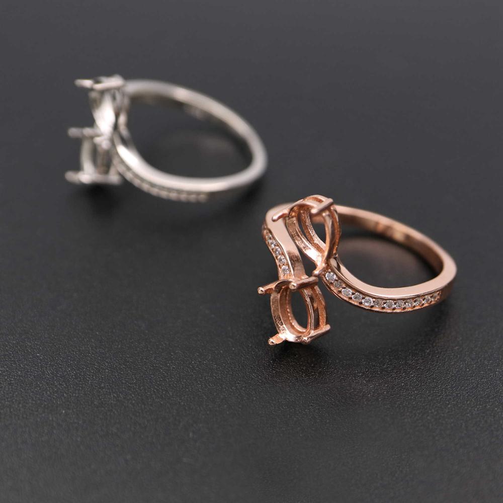One silver and one rose gold oval wrap around bypass pave semi mounts.