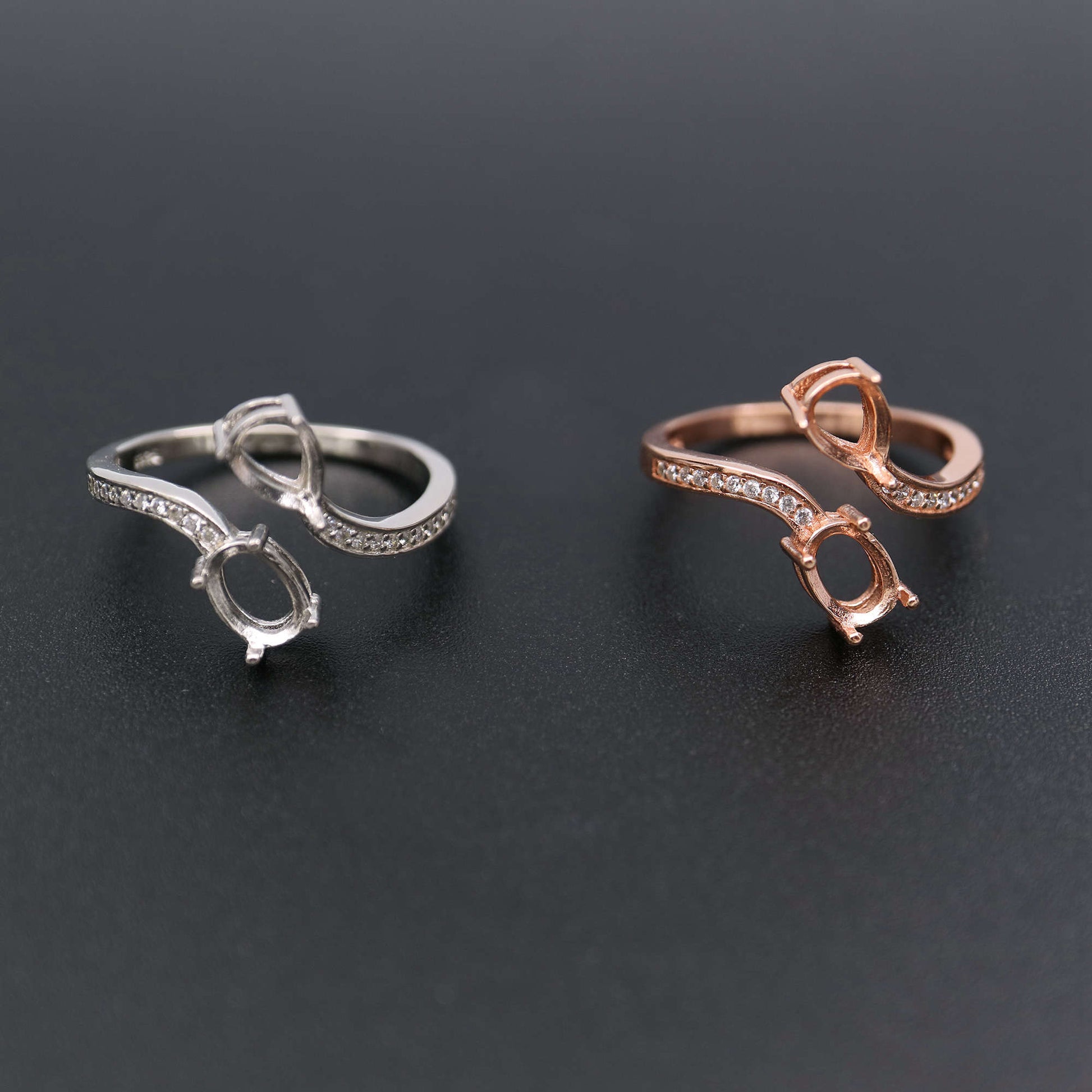 One silver and one rose gold oval wrap around bypass pave semi mounts.