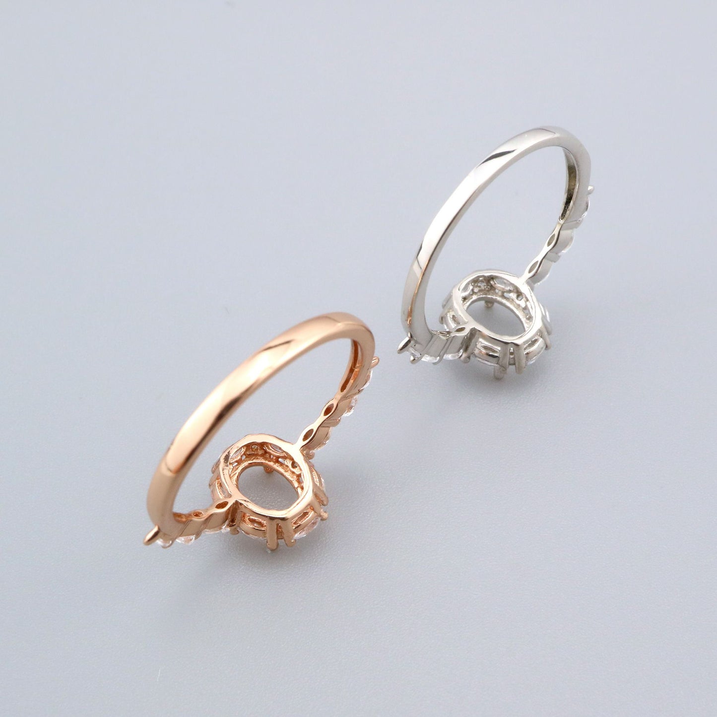 One rose gold and one silver vintage style halo semi mount with pave marquise gems.