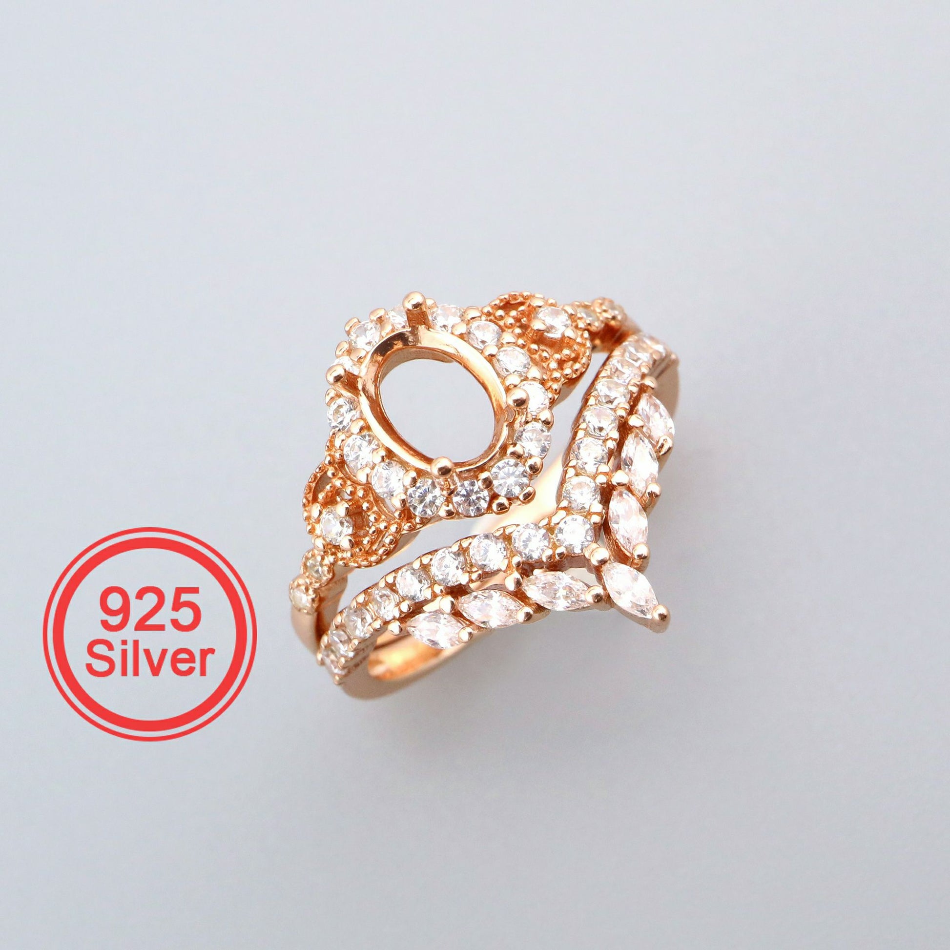 A rose gold oval halo with extra detail and a matching chevron wedding ring.