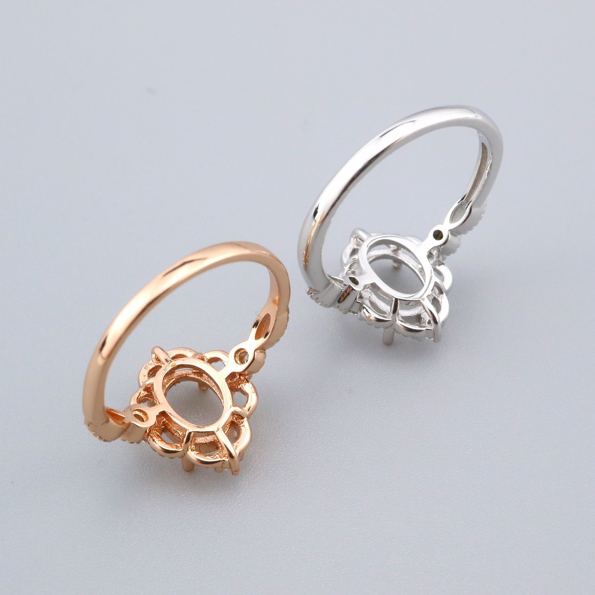 One silver and one rose gold lacey style oval vintage halo semi mounts.