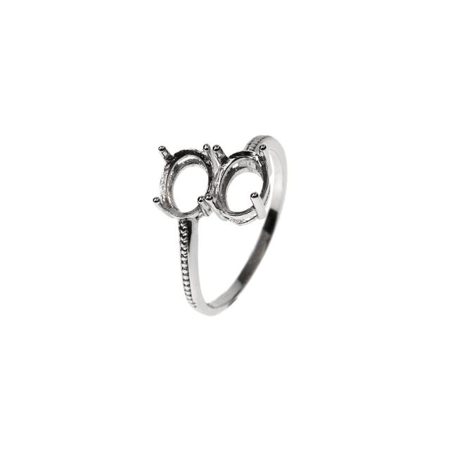 A silver "one size fits all" wrap around ring, that fits one oval gem on each side of the pave style shank.