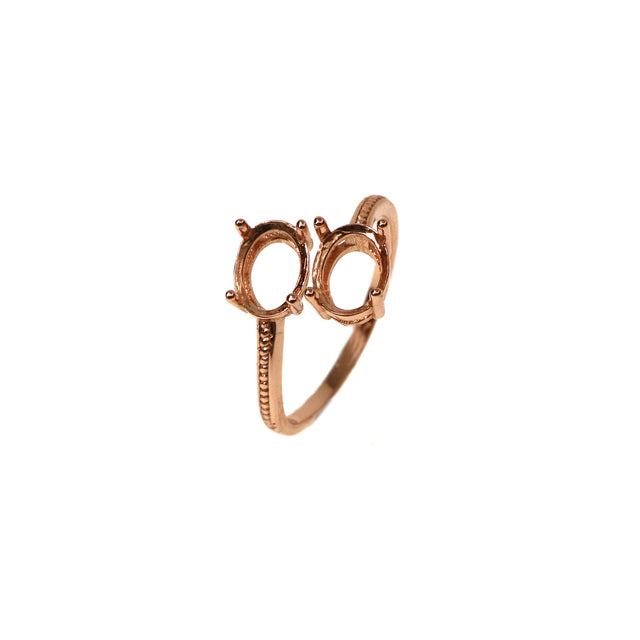 A rose gold "one size fits all" wrap around ring, that fits one oval gem on each side of the pave style shank.