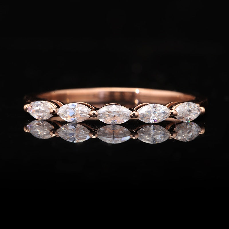 A rose gold half eternity band set with five marquise cut moissanites.
