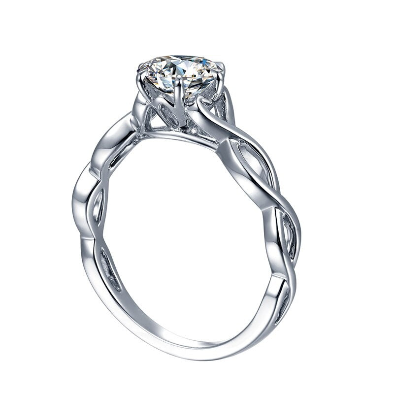 A silver twisted shank engagement ring set with a round moissanite.