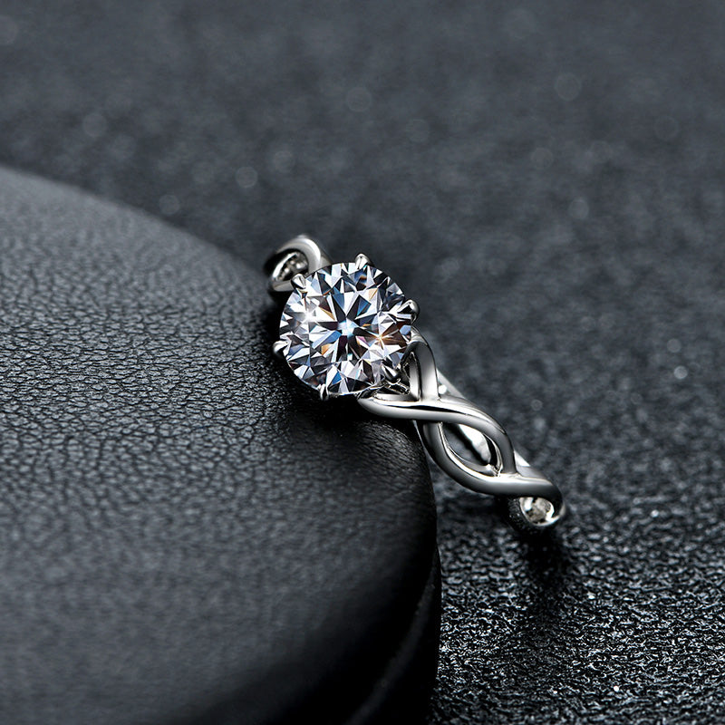 A silver twisted shank engagement ring set with a round moissanite.