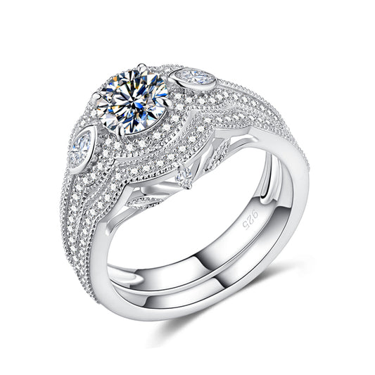 A silver iced out filigree engagement ring and matching curved wedding ring.