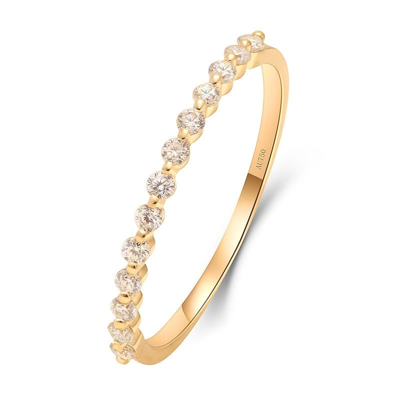 A gold bubble band wedding ring with sparkling moissanite gems.