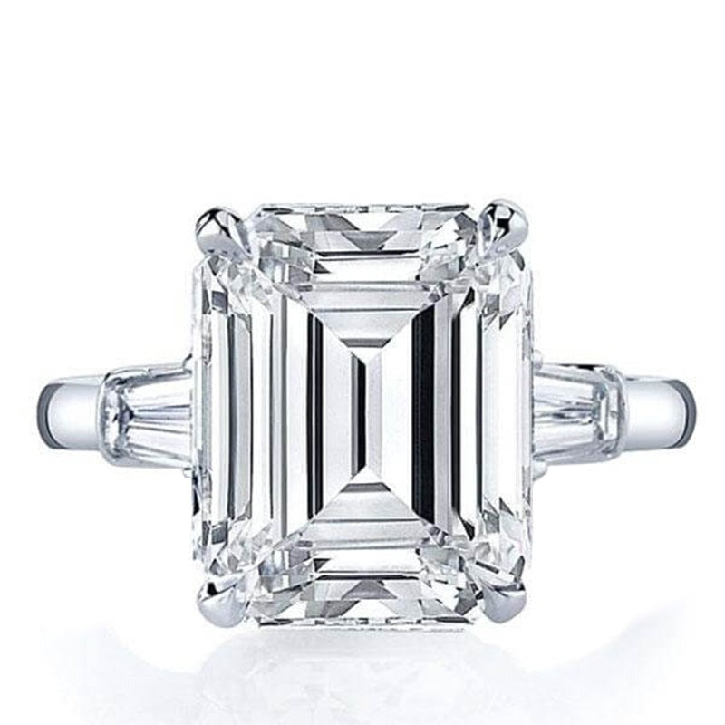 A Large silver emerald cut moissanite 3 stone ring.