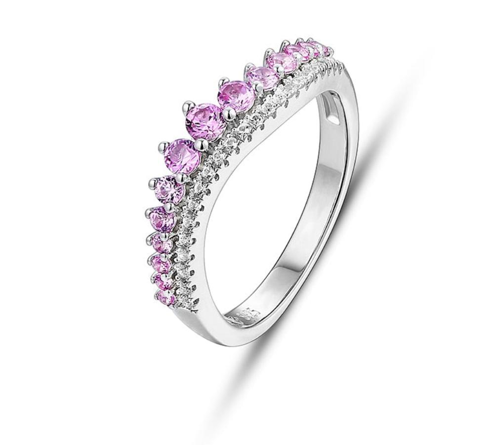 A silver wave design band with varying size pink sapphires and small clear gems below the sapphires.