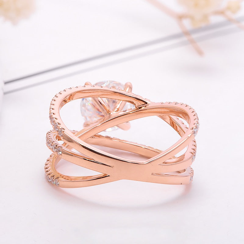 A rose gold pave triple banded ring set with  round moissanite in the center.