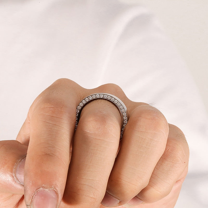 A silver thick wedding ring with moissanite encrusted sides.