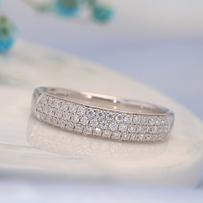 A wide silver wedding band with tiny inset gems.