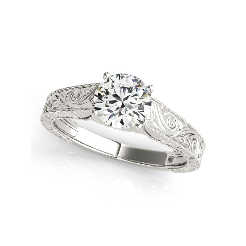 A silver embossed swirl design shank set with a round cut moissanite.