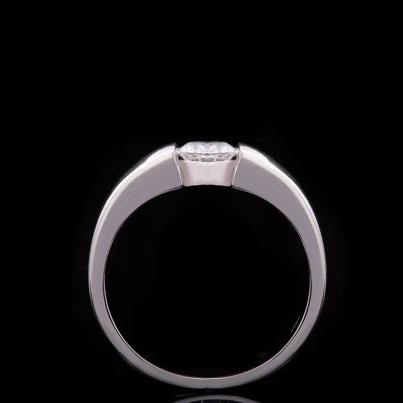 A silver band tension set with a round clear gem.
