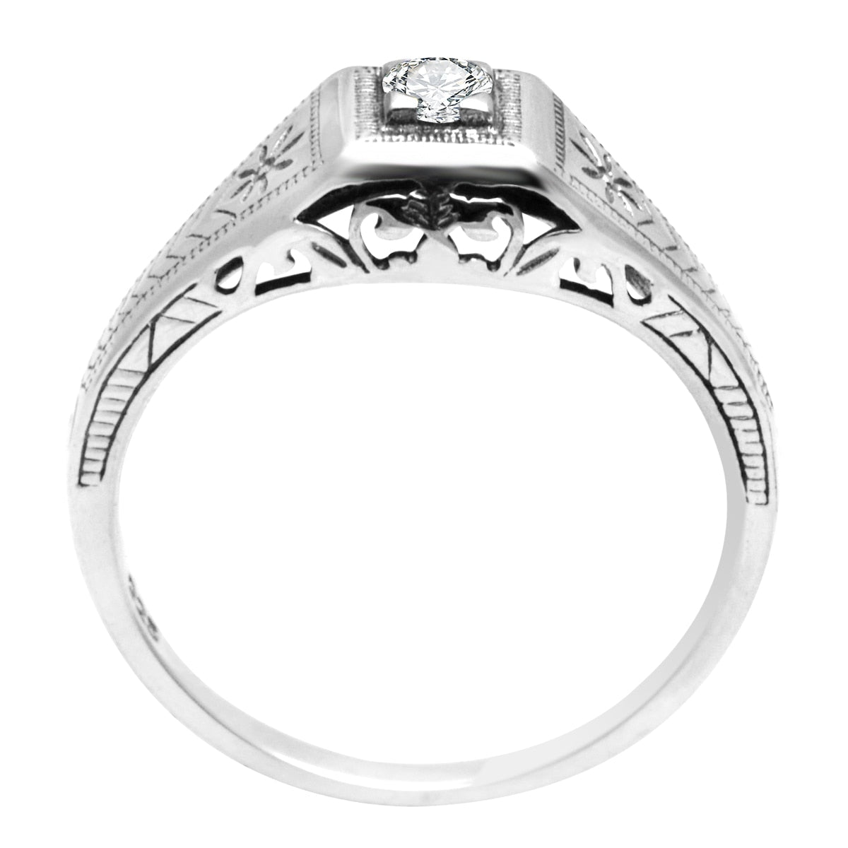 A silver vintage inspired Edwardian style ring set with a small round moissanite.