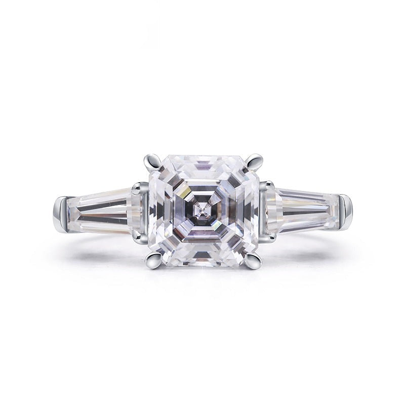A silver 3 stone ring set with a Ascher cut moissanite nestled between two baguette moissanites.