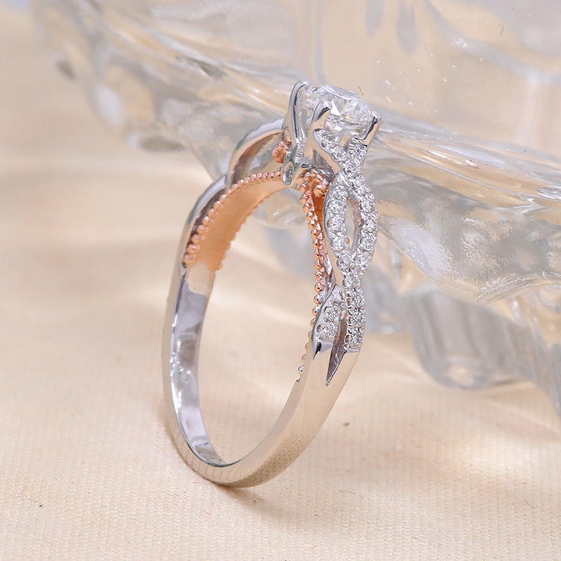 A two tone silver and rose gold filigree hollowed out round engagement ring.