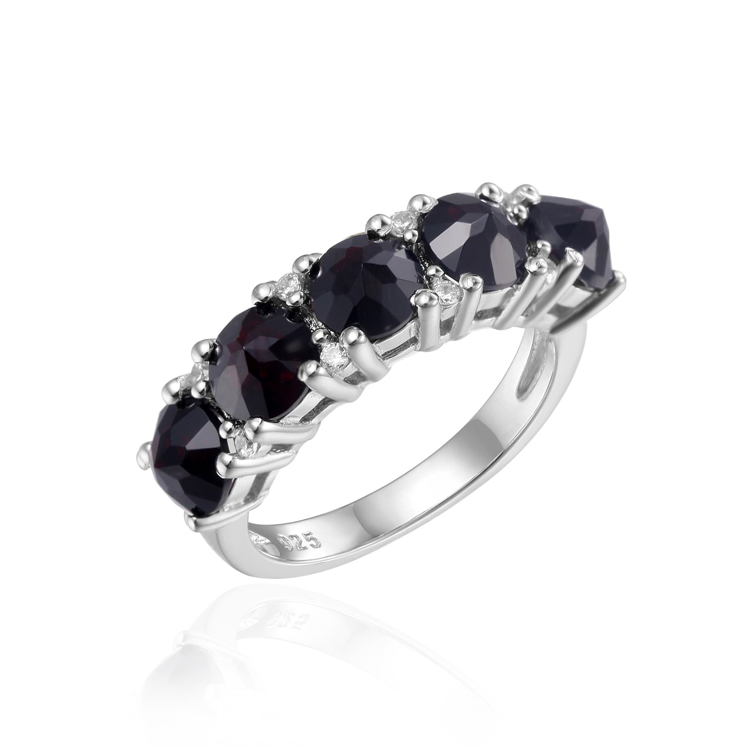 A silver ring set with five black gems.