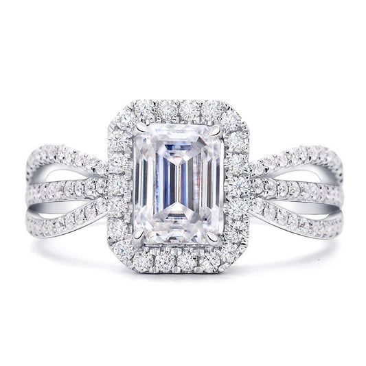 A silver emerald cut halo ring with a triple split pave band.