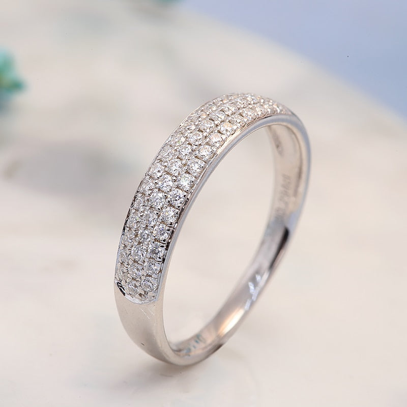 A wide silver wedding band with tiny inset gems.