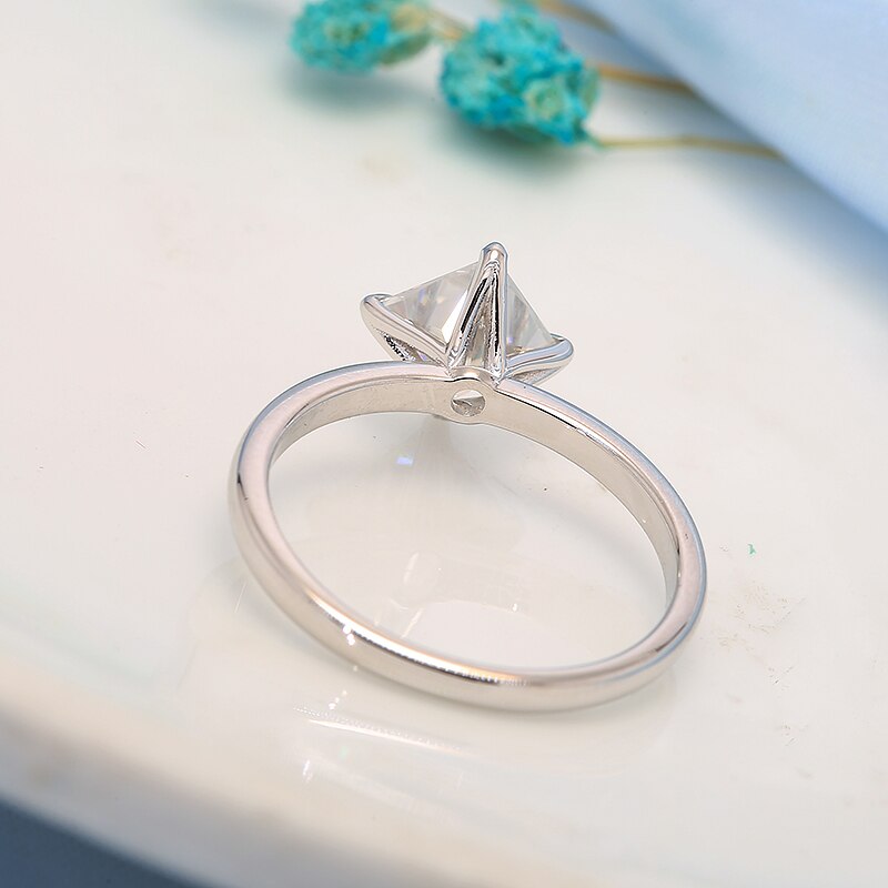 Solid white gold princess cut, prong set at an angle moissanite engagement ring.