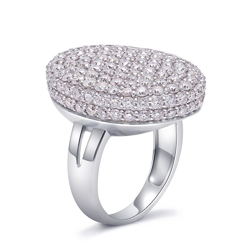 A oval shaped silver gem encrusted thick shield style ring.