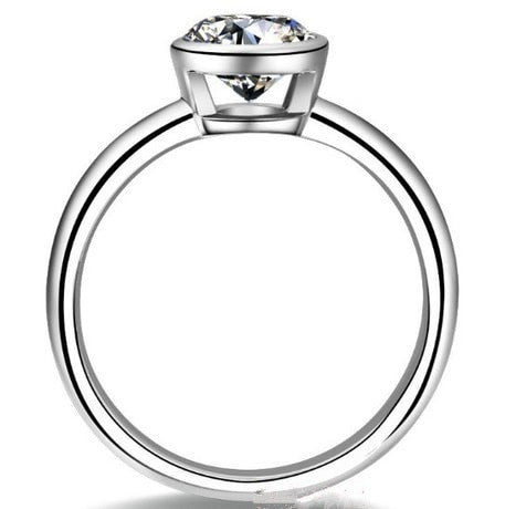 A silver shank bezel set with a round moissanite.