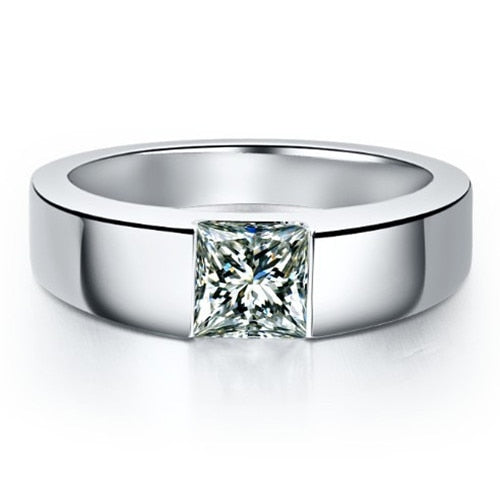 A silver thick banded ring, tension set with a 1CT princess cut moissanite.
