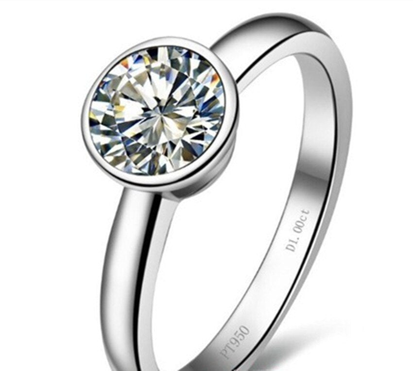 A silver shank bezel set with a round moissanite.