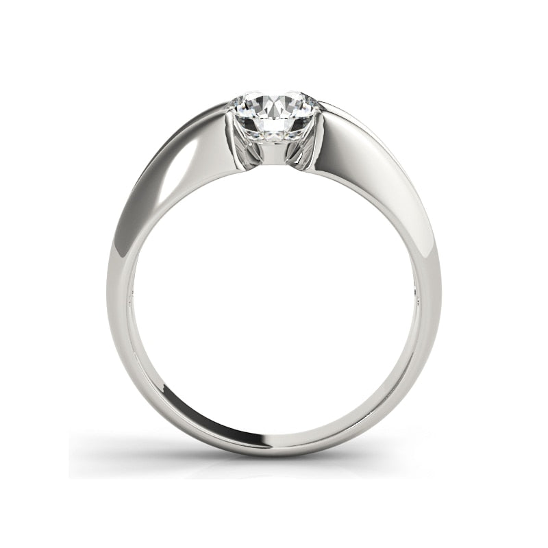 A silver thick split shank ring, tension set with a round moissanite.