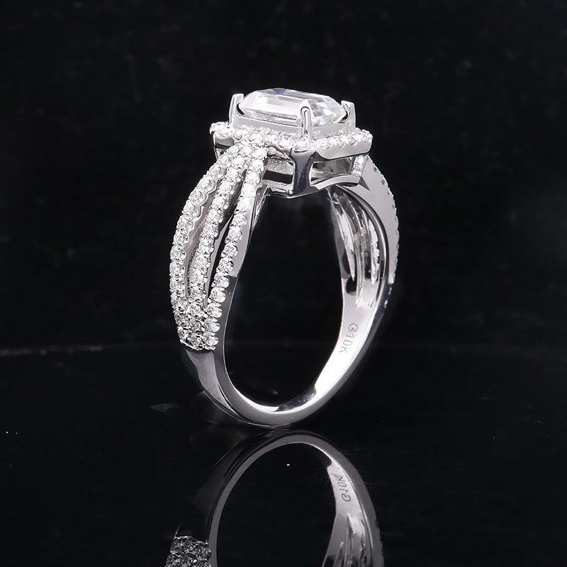 A silver emerald cut halo ring with a triple split pave band.