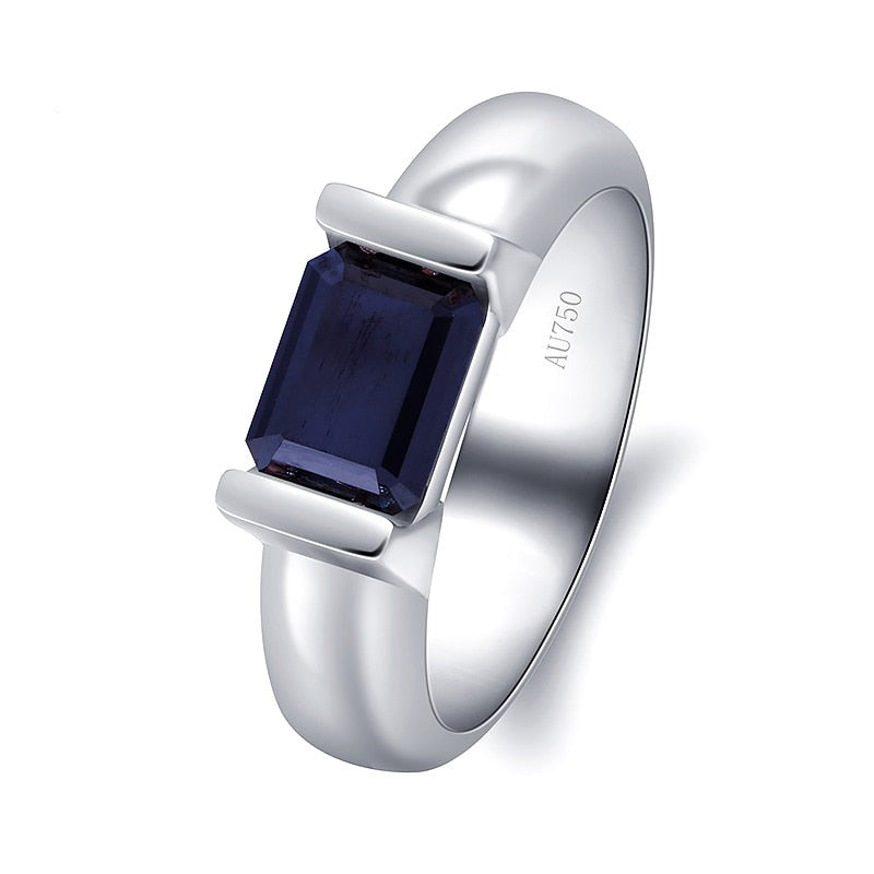 A silver ring with an emerald cut black moissanite side east to west in a tension setting.