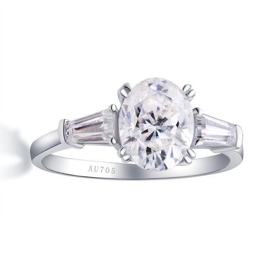 Solid white gold oval cut moissanite 3 stone engagement ring with accent baguettes on each side.