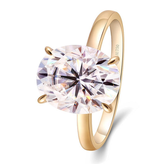 A gold band solitaire set with petal style prongs holding a 3CT oval moissanite.
