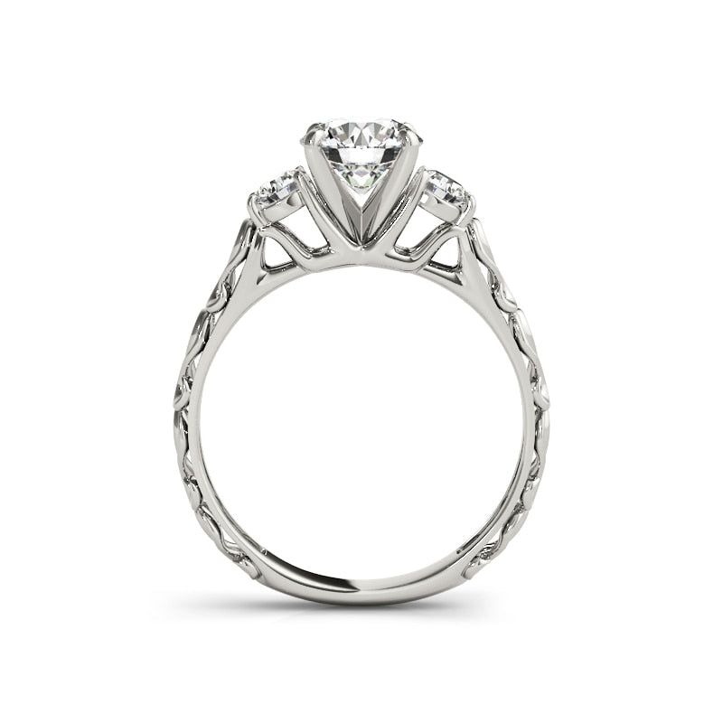 A silver filigree ring set with a 1CT moissanite and a smaller gem on each side.