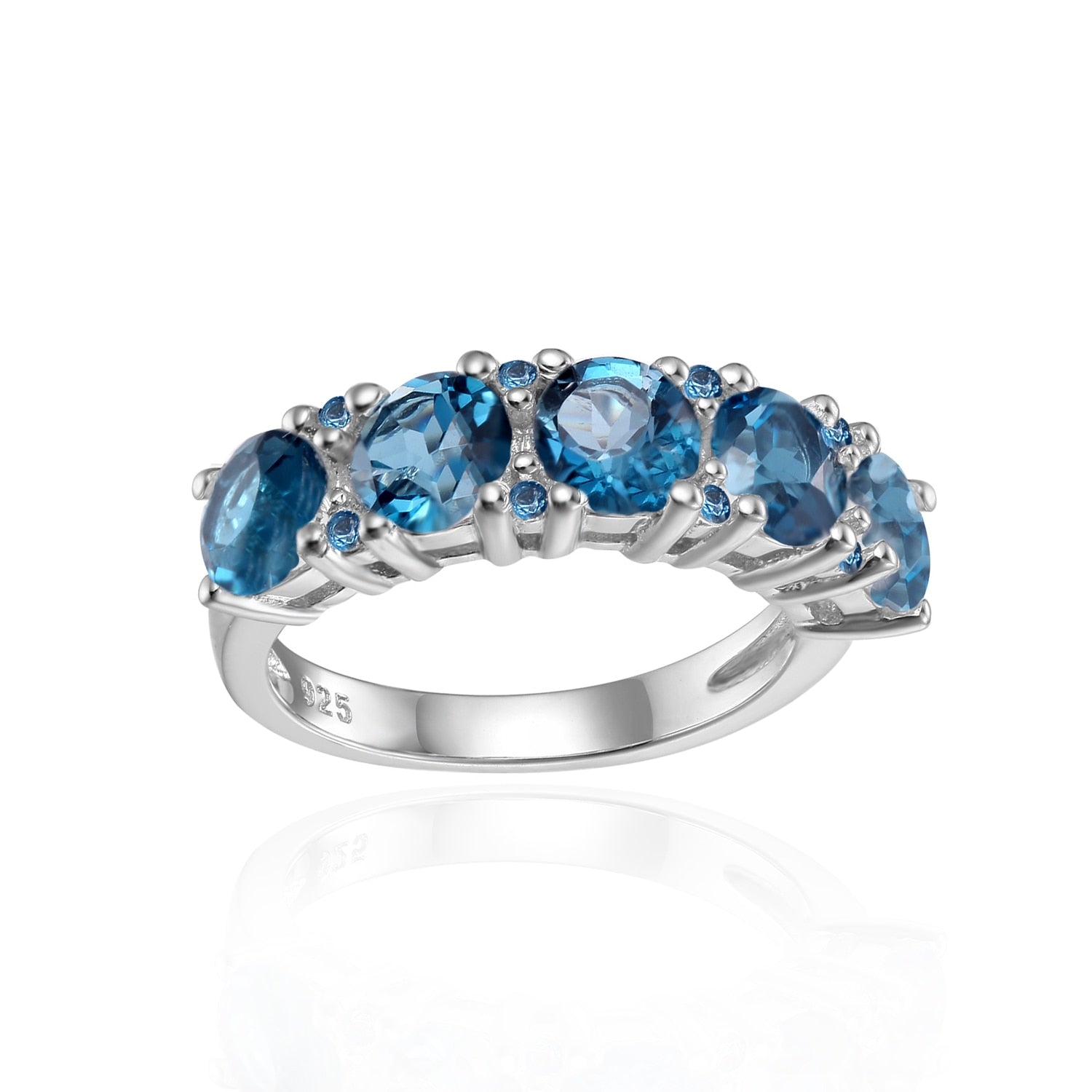 A silver ring set with five bluish green gems.